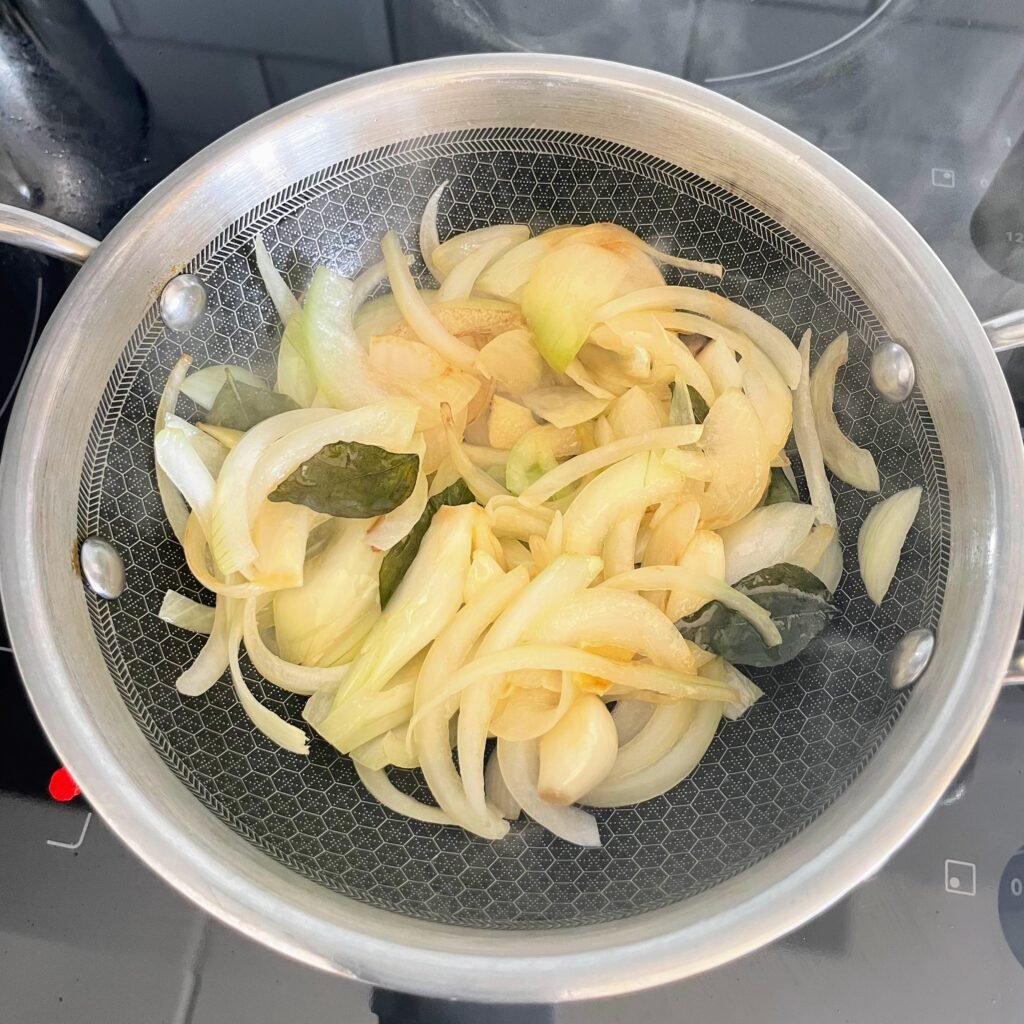 Frying aromatics in ghee to make the masala paste for Chicken Sukka